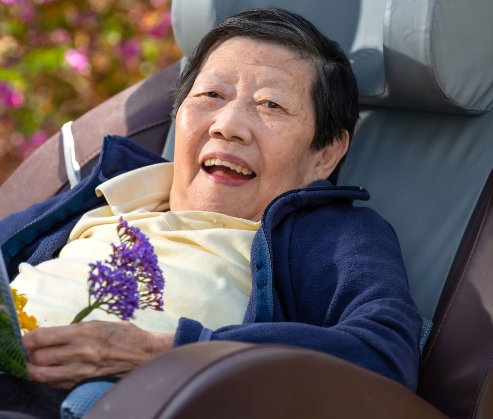 Eldercare Trowbridge House resident Sau Wong looking into the camera and smiling.