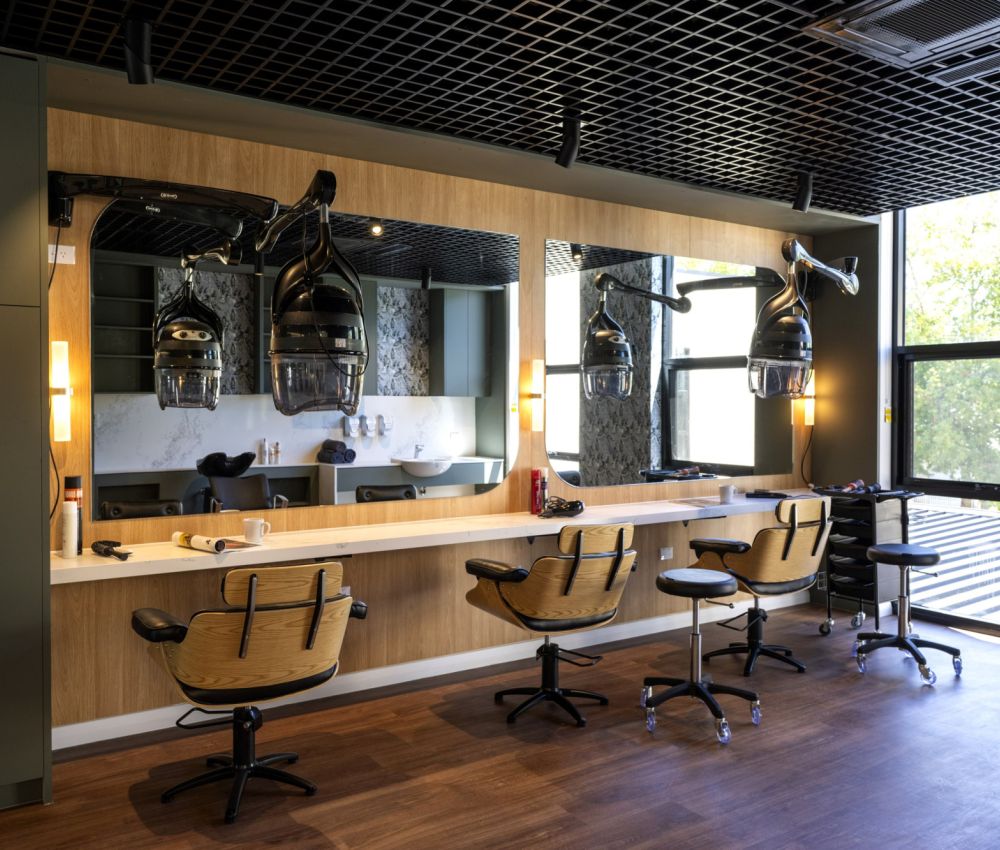 A hairdresser area at Eldercare Goodwood aged care site featuring chairs and mirrors, designed for comfort and accessibility.