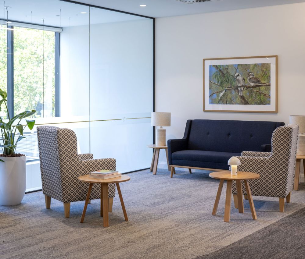 Comfortable lounge area at Eldercare Goodwood aged care, showcasing chairs and a calming painting for visitors.