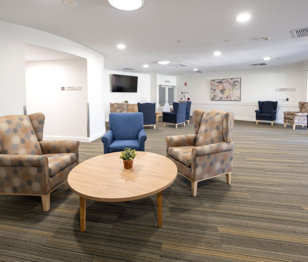 Eldercare Hope Valley sitting area with armchairs and tables.
