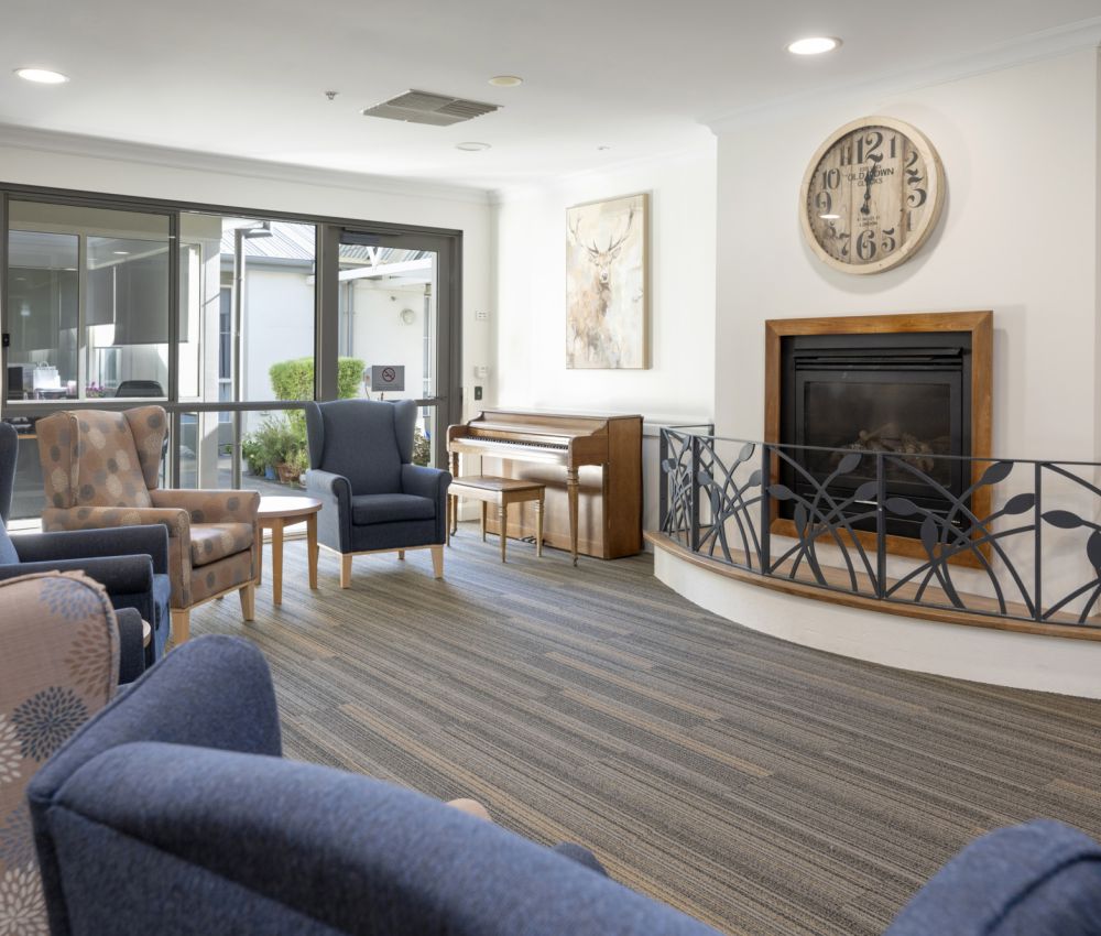 Eldercare Hope Valley sitting area with armchairs and fireplace.