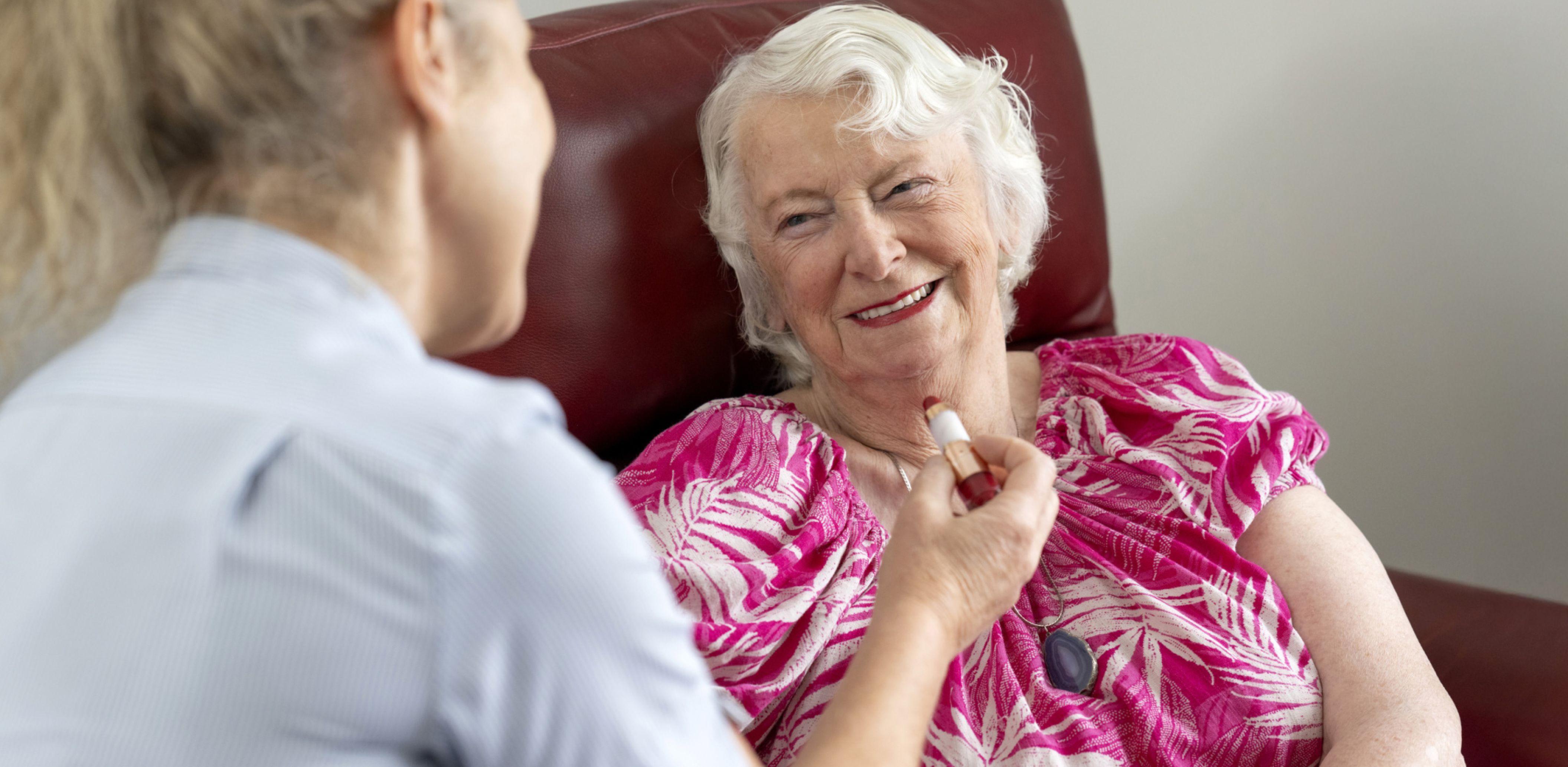 An Eldercare resident engages in conversation with a carer, highlighting a moment of care and connection.