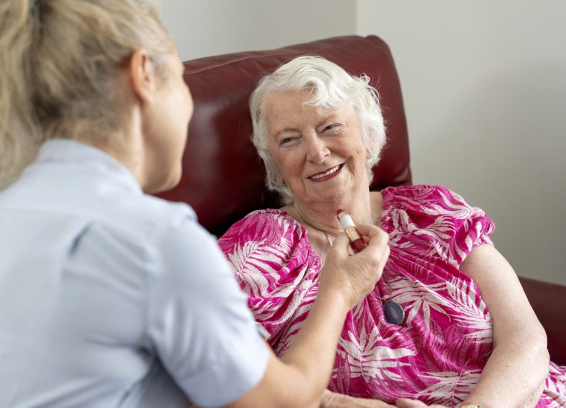 An Eldercare resident engages in conversation with a carer, highlighting a moment of care and connection.