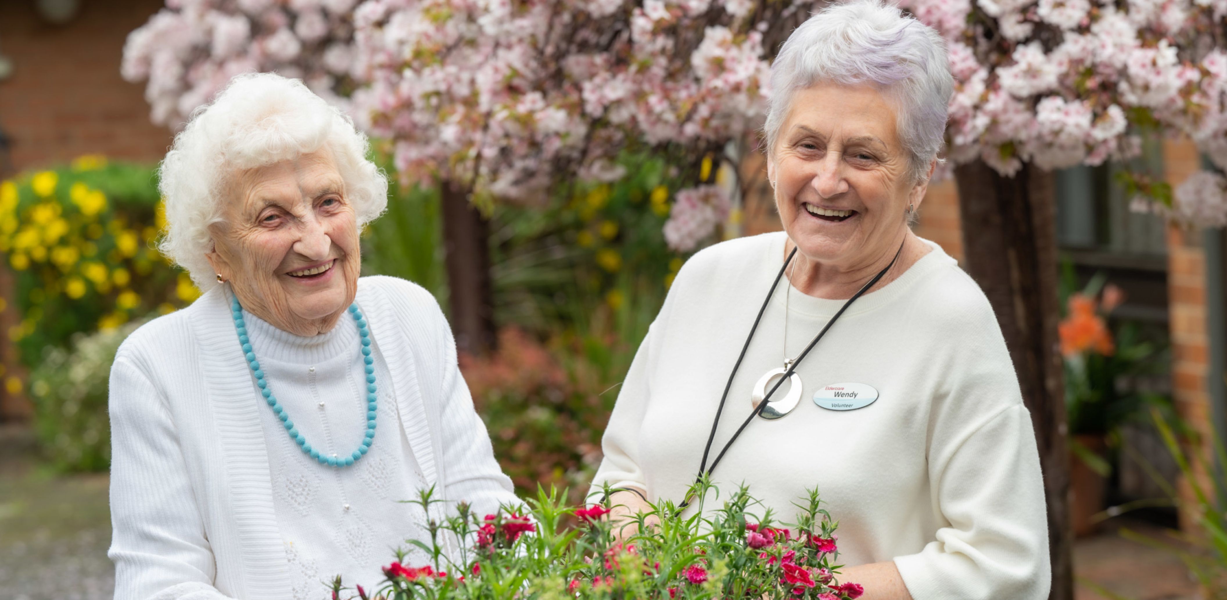 Eldercare Sash Ferguson resident and a volunteer smiling at camera.
