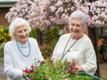 Eldercare Sash Ferguson resident and a volunteer smiling at camera.