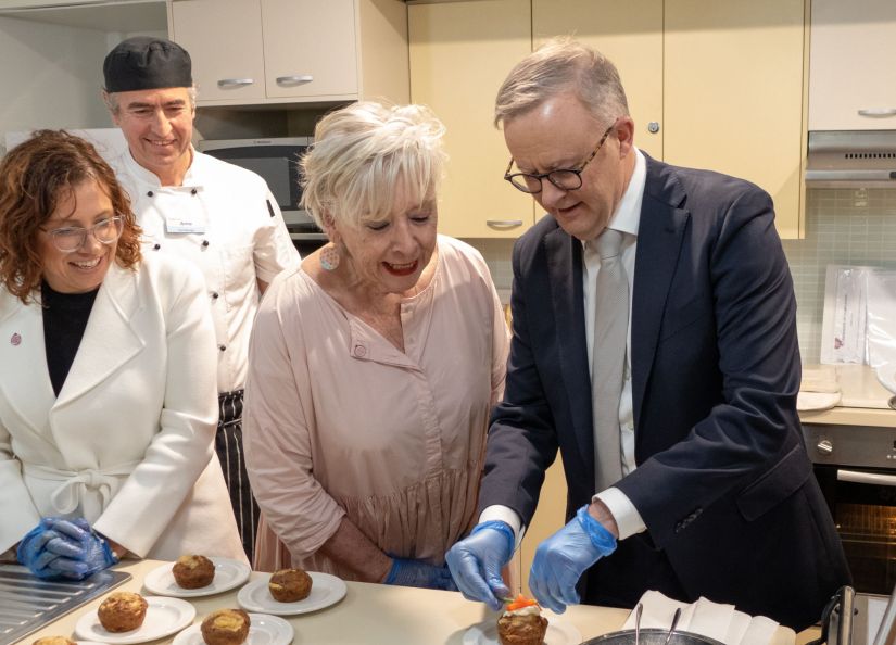 Prime Minister Anthony Albanese plates up afternoon tea with the Hon Amanda Rishworth MP, Eldercare Seaford Chef Manager Arno Egle and Maggie Beer looking on.