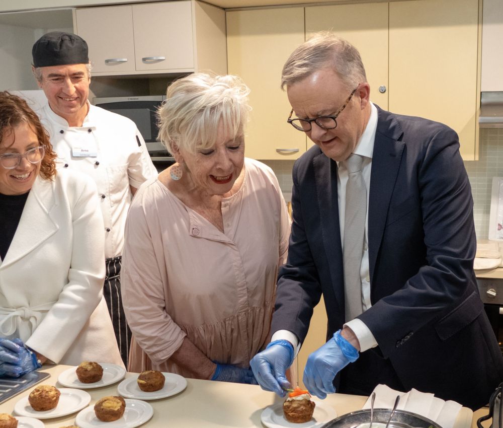 Prime Minister Anthony Albanese plates up afternoon tea with the Hon Amanda Rishworth MP, Eldercare Seaford Chef Manager Arno Egle and Maggie Beer looking on.