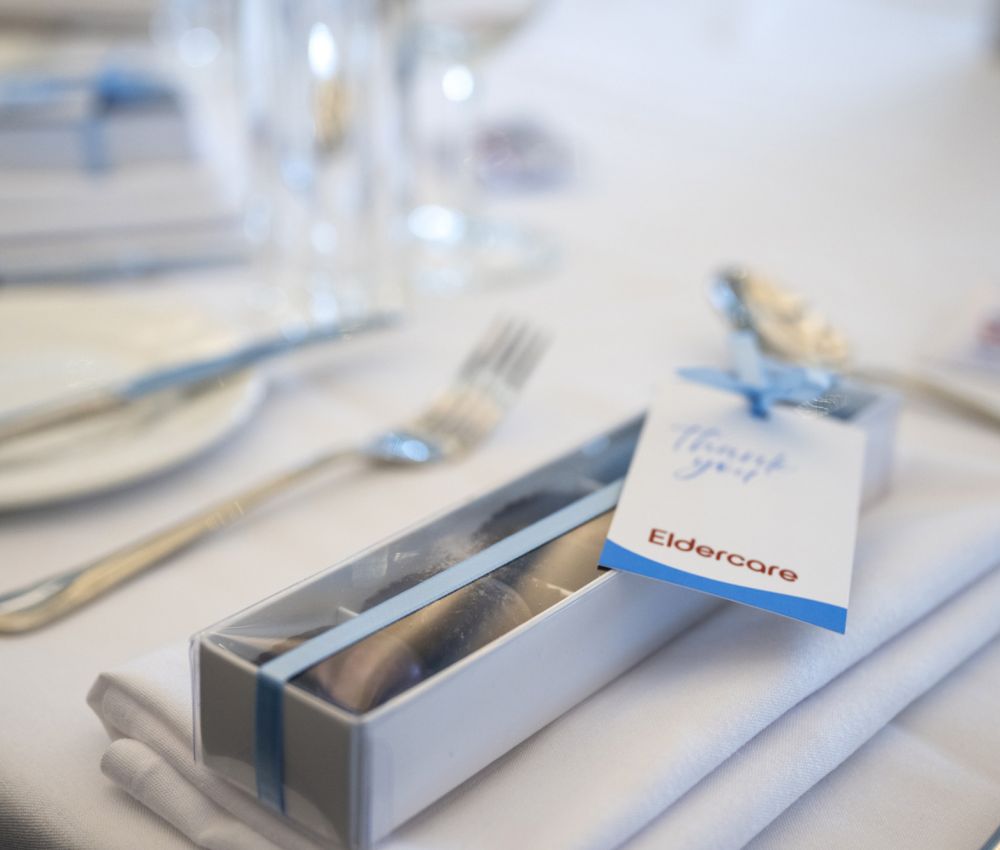 A table displaying silverware and a place setting, prepared for a dining experience.